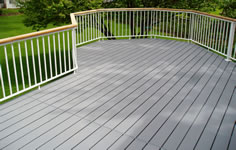 Versadeck aluminum modular decking photo showing the Light Slate Grey color option and picket aluminum railing with a wood rail top.